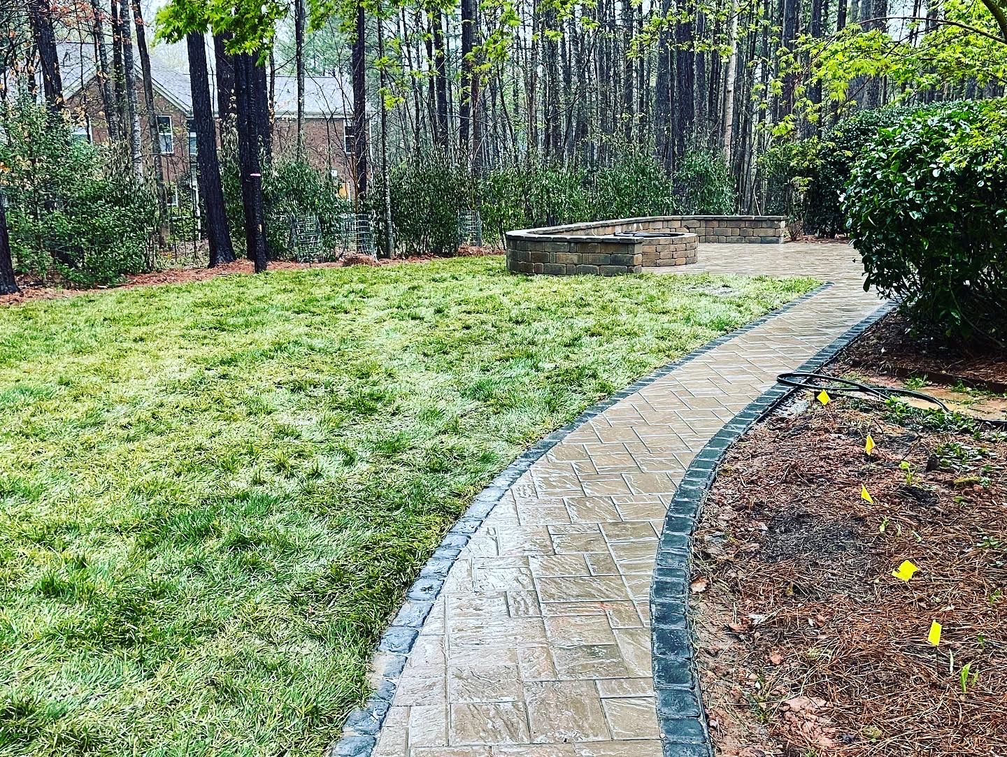 newly built sidewalk with a fire pit.